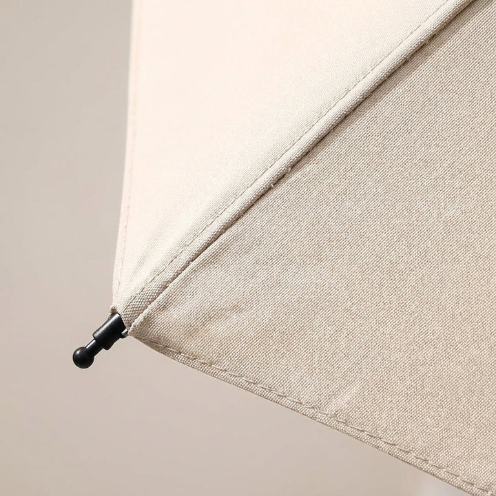 Durable mini travel umbrella, foldable and designed with a convenient clip for easy attachment.