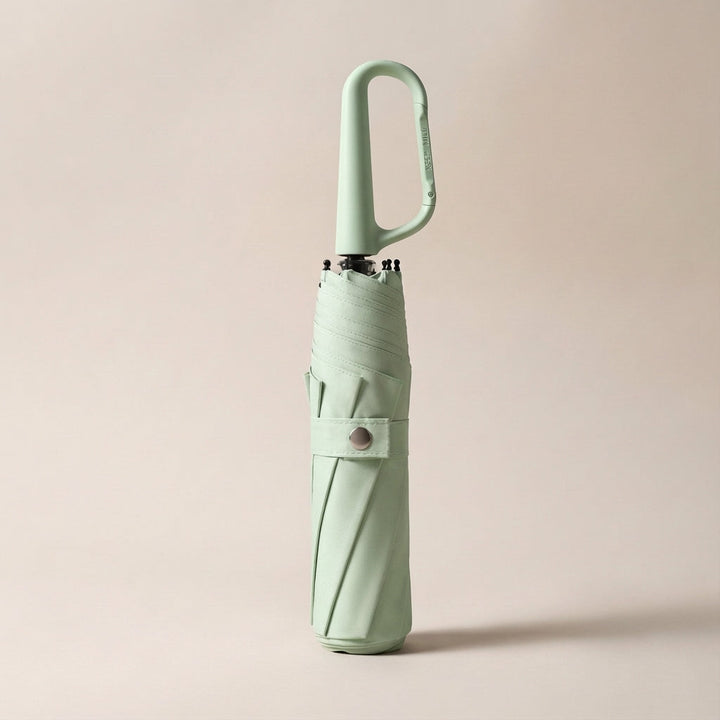 Open compact umbrella showing its waterproof canopy and sturdy frame, providing all-weather protection.