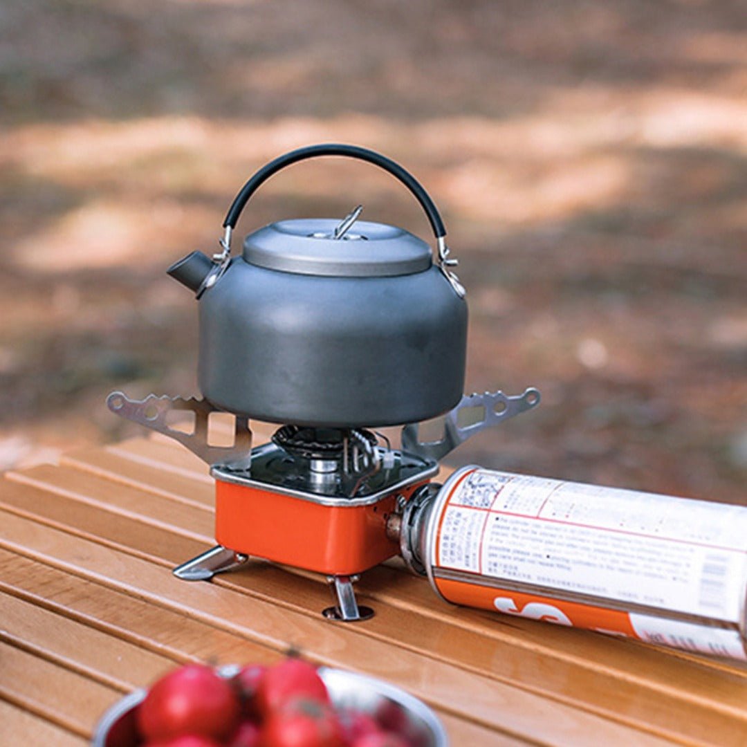 Emergency prep portable cooking stove with gas canister attached, ready for use on a stable surface