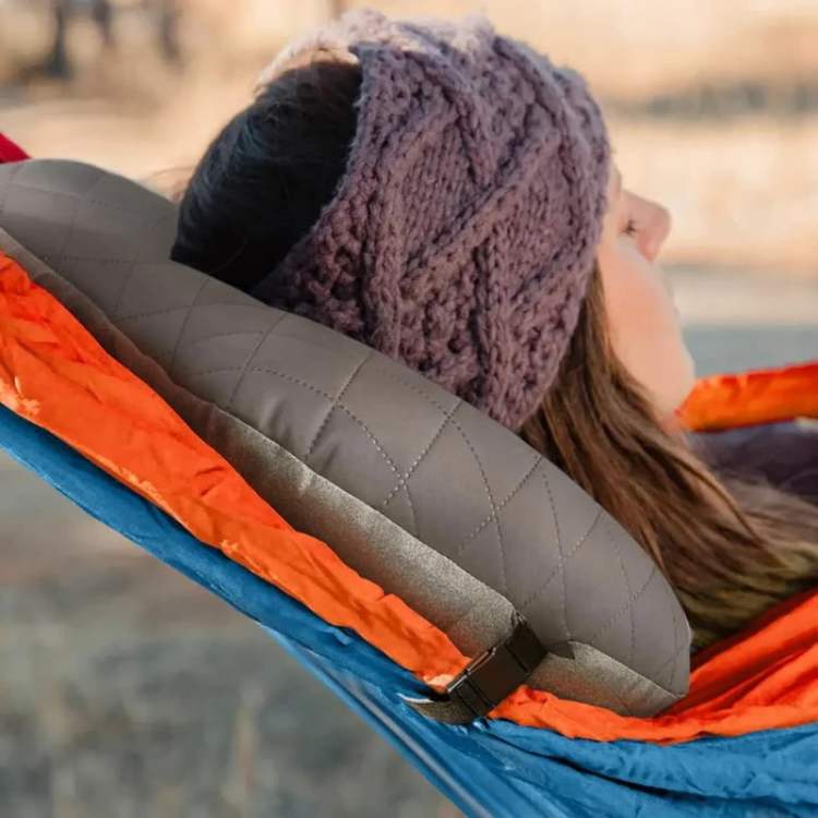 Small deflated inflatable camping pillow for easy packing, essential camping sleeping gear