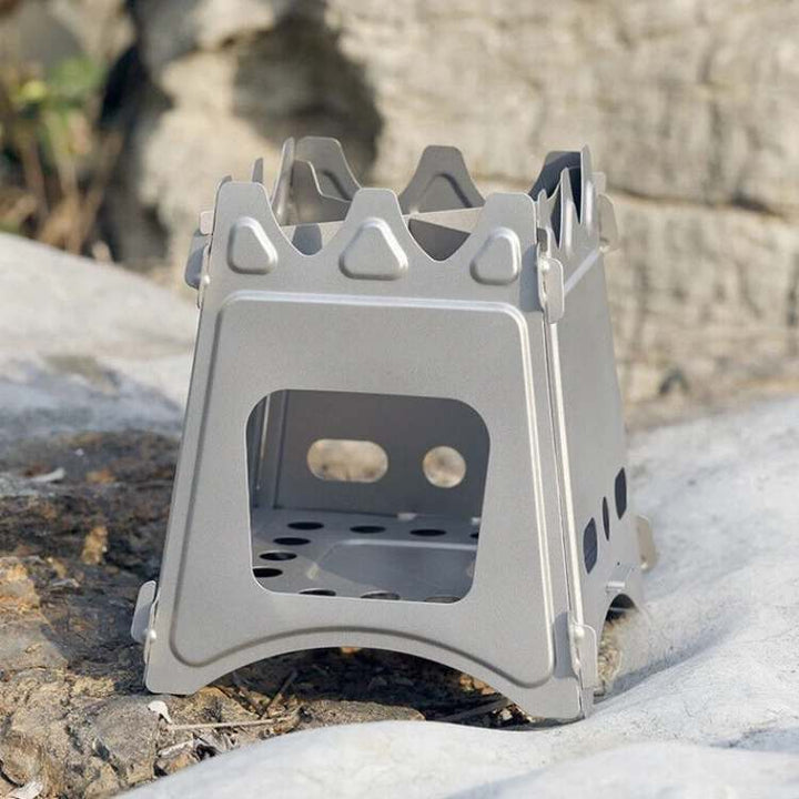 Compact stainless steel wood burning camping stove for outdoor cooking, portable hiking gear