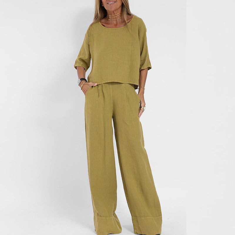 "Completo estivo lino donna, top manica corta e pantaloni ampi in tessuto leggero, eleganza casual per giornate soleggiate."