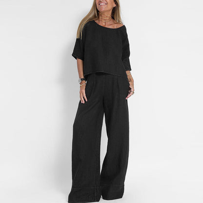 "Completo estivo lino donna, top manica corta e pantaloni ampi in tessuto leggero, eleganza casual per giornate soleggiate."