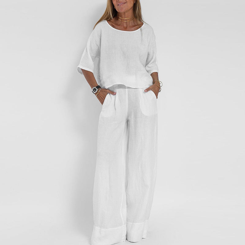 "Completo estivo lino donna, top manica corta e pantaloni ampi in tessuto leggero, eleganza casual per giornate soleggiate."