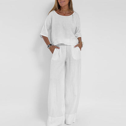 "Completo estivo lino donna, top manica corta e pantaloni ampi in tessuto leggero, eleganza casual per giornate soleggiate."
