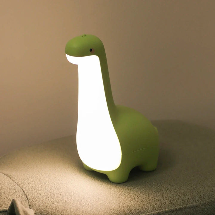 Soft silicone LED dinosaur night light. Gentle glow for nursery & kids' room decor. Rechargeable.