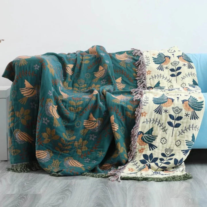 Stylish reversible Scandinavian bird blanket. Cotton throw adds cozy comfort & Nordic flair to any living room.