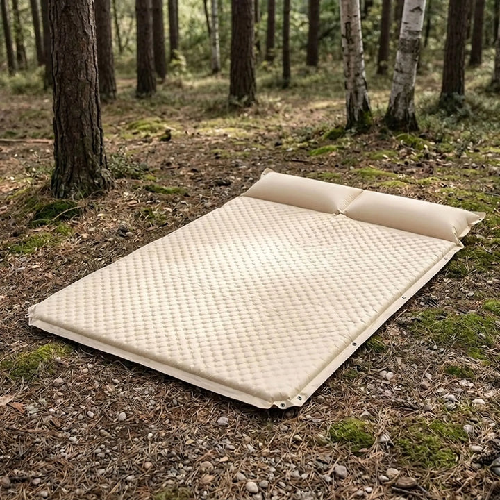 Cream self-inflating camping sleeping pad with integrated pillow for comfortable hiking & backpacking.