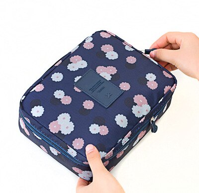 Travel-friendly dark blue floral waterproof makeup bag, compact with bonus mini cosmetic storage.