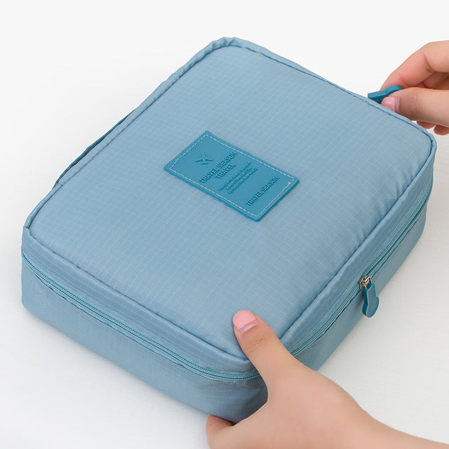 Compact dark blue floral waterproof makeup organizer for women, durable and perfect for any journey.