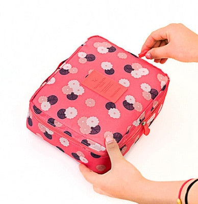 Elegant dark blue floral waterproof travel cosmetic case, includes free mini organizer for small items.
