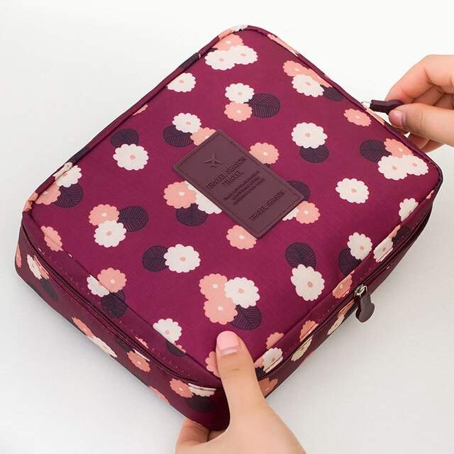 Portable dark blue floral waterproof cosmetic bag, perfect for travel, everyday use, and beauty storage.