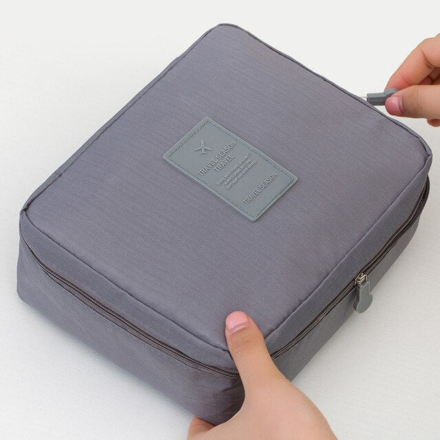 Compact dark blue floral waterproof makeup storage case, ideal for keeping toiletries organized on trips.