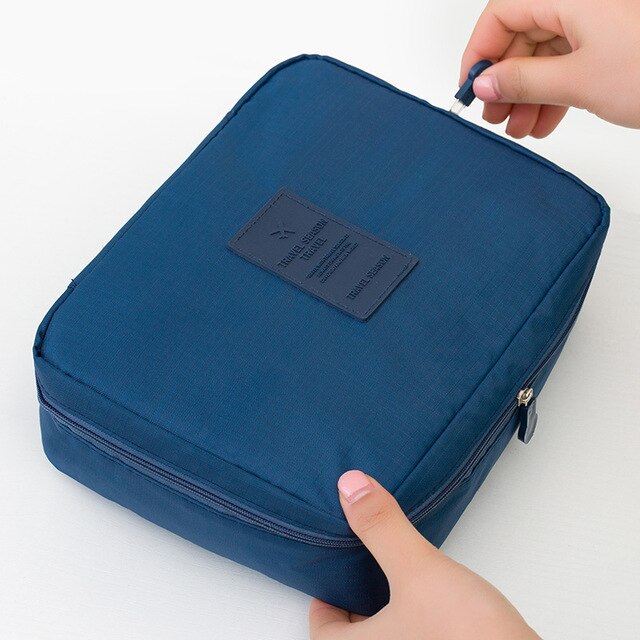 Dark blue floral waterproof travel makeup organizer for women, compact and includes a free mini case.