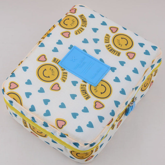 Waterproof travel makeup bag in dark blue floral, perfect for organized beauty storage & everyday use.
