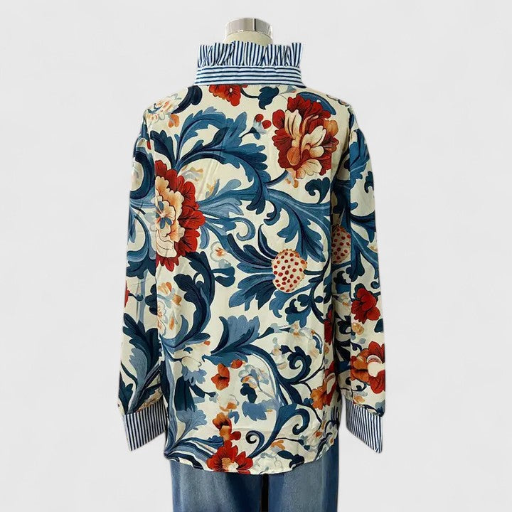 Close-up of a dark blue women's blouse, showcasing its beautiful 3D floral details and elegant, modern design.