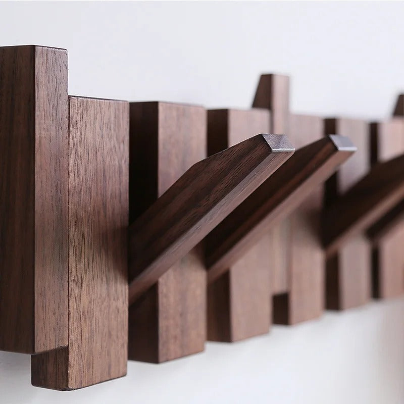 Hallway furniture: wooden piano coat rack, a decorative wall organizer with practical hooks.
