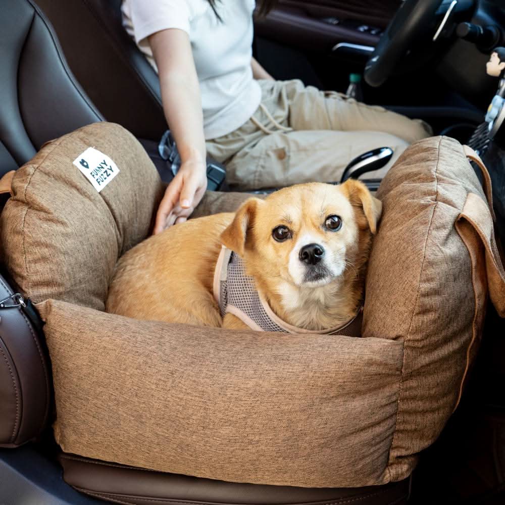 Make car journeys safer with this dog booster seat, featuring a safety belt & comfortable pet bed.