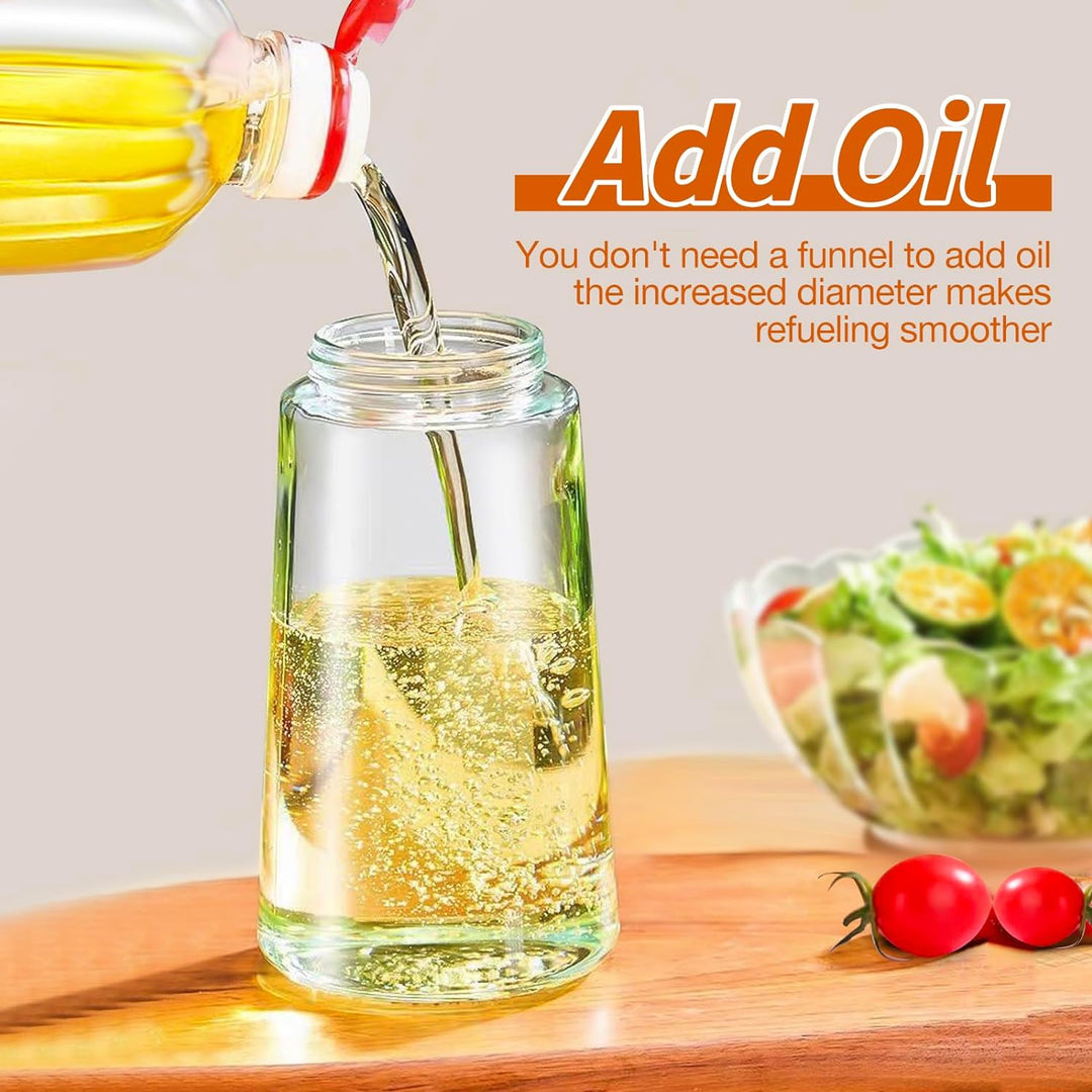 Modern kitchen olive oil sprayer with dual function. Glass dispenser for healthy cooking and food prep.