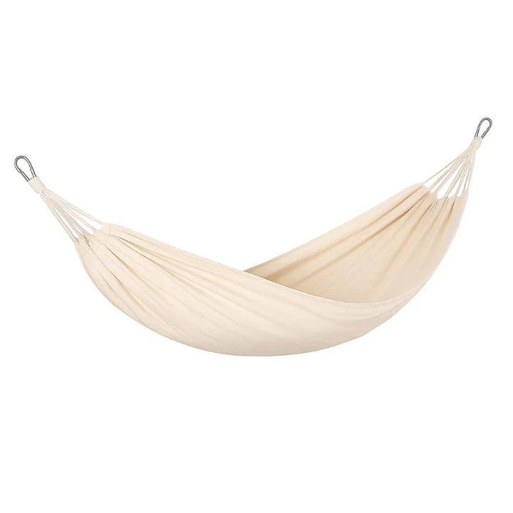 Portable camping gear: canvas hammock with spreader bars, designed for anti-rollover stability at beach or camp
