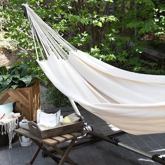 Adventure-ready canvas anti-roll hammock with strong spreader bars, perfect for camping, picnics, or beach days
