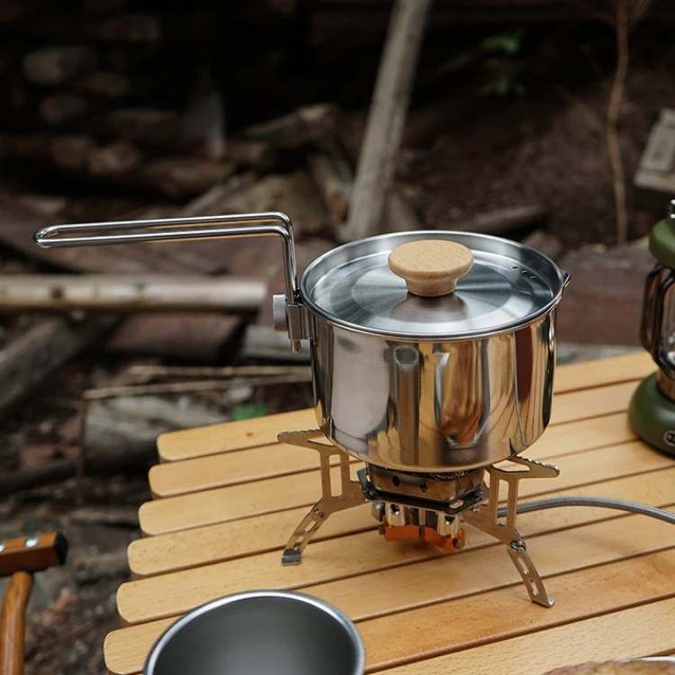 Durable stainless steel camping kettle for outdoor cooking, portable and lightweight for backpacking.