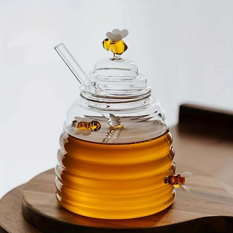 Elegant beehive glass honey jar with dipper, perfect for kitchen decor & serving.
