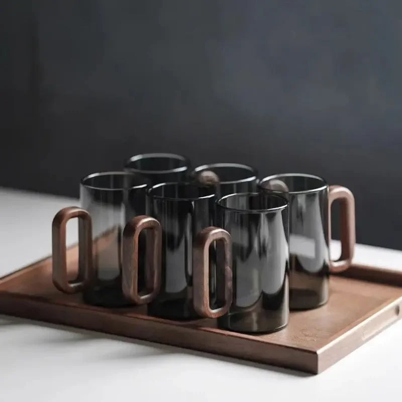Modern borosilicate black drinking glass with a distinctive walnut handle. A stylish addition to any kitchen setting.