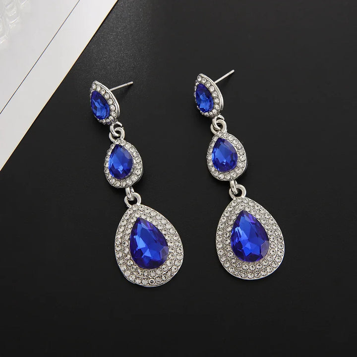 Women's stunning emerald cascade drop earrings, a vibrant green elegant accessory for any occasion.