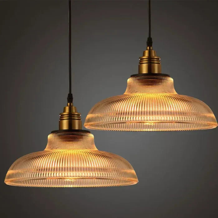 Elegant glass pendant light, modern ceiling fixture for contemporary home decor, adds warm ambient glow.