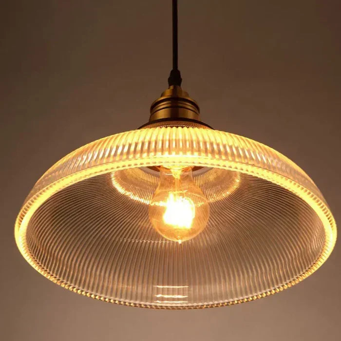 Sleek glass pendant light for modern dining room or kitchen island, elegant decorative ceiling lamp.