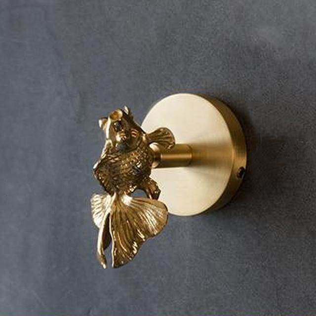 Detailed gold animal decorative hook for sophisticated wall decor and home accessories.