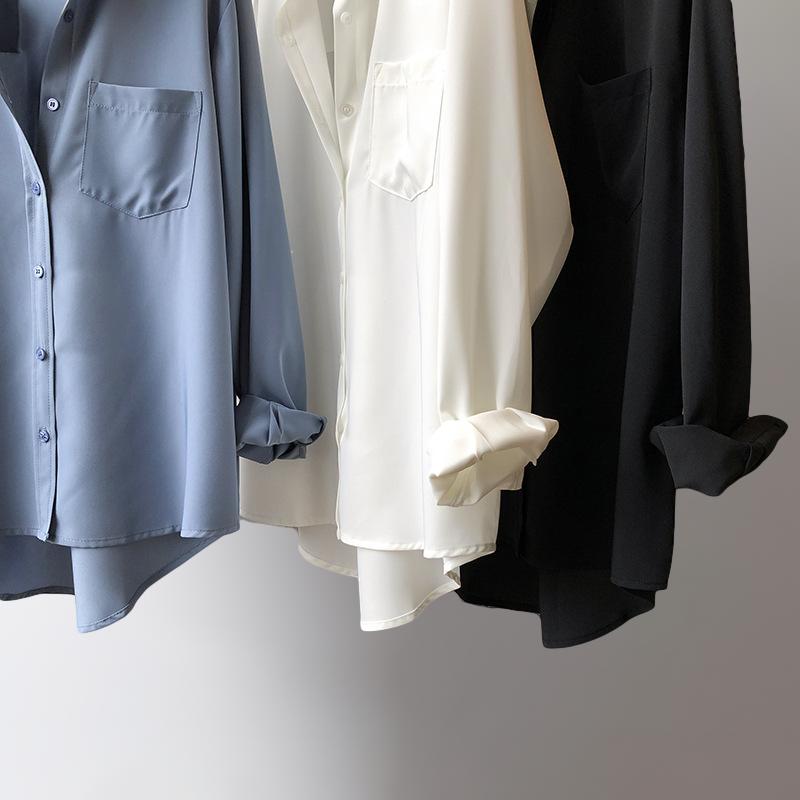 Sophisticated women's high-low blouse. Flowy long sleeve top with elegant drape, perfect for chic wear.