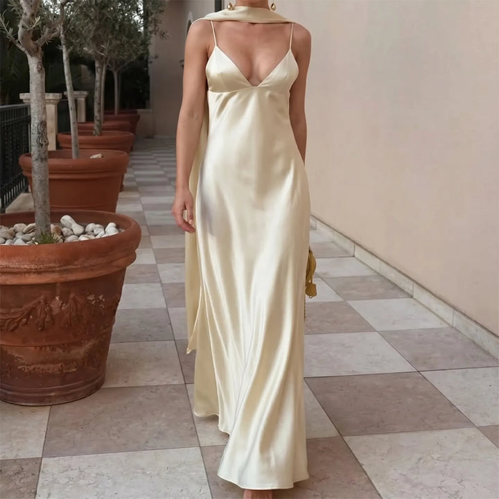 Elegant light yellow open back slip dress for women, featuring a chic scarf detail. Perfect for summer events.