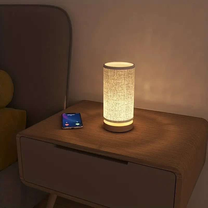 Modern LinoGlow bedside lamp with a linen look finish, perfect for elegant home decor & ambient lighting.