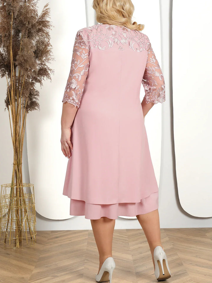 Intricate embroidery & sheer sleeve detail on a plus size elegant formal dress. Perfect for special evening occasions.