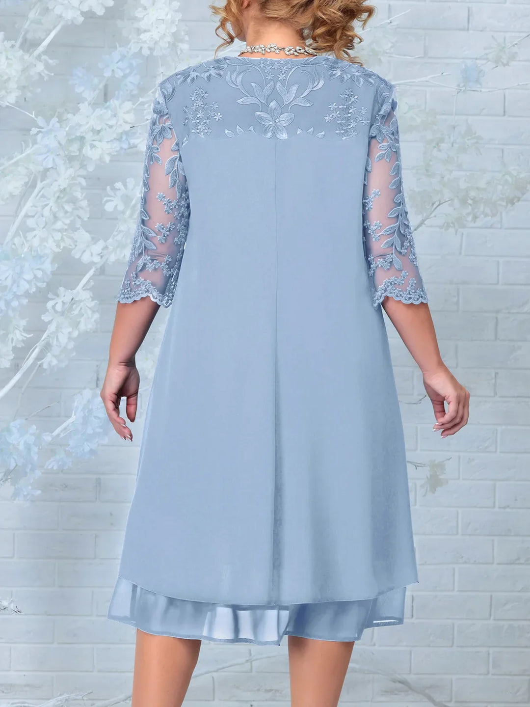 Full length view of a stunning plus size long evening dress for women. Embroidered design, sheer sleeves for formal events.