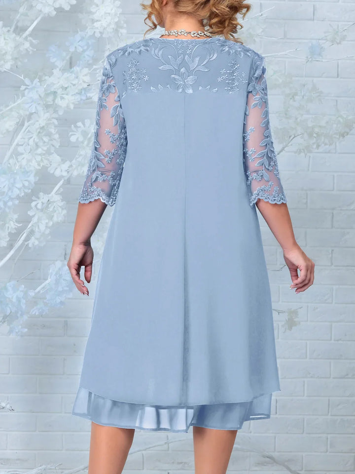 Full length view of a stunning plus size long evening dress for women. Embroidered design, sheer sleeves for formal events.