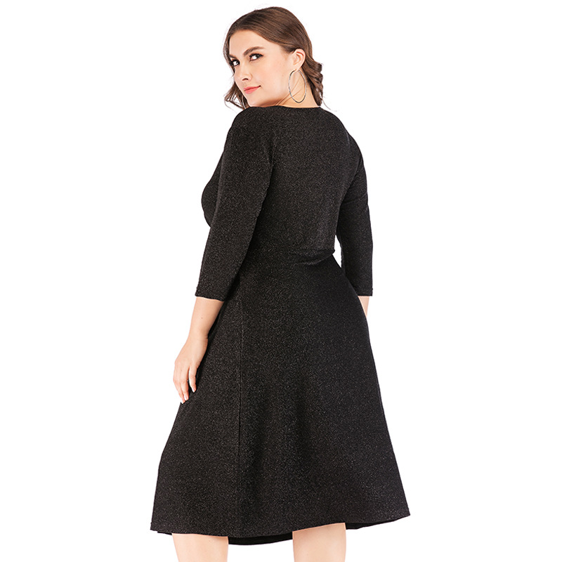 Curvy women's long sleeve glitter cocktail dress. Stylish plus size wrap gown for evening or festive wear.