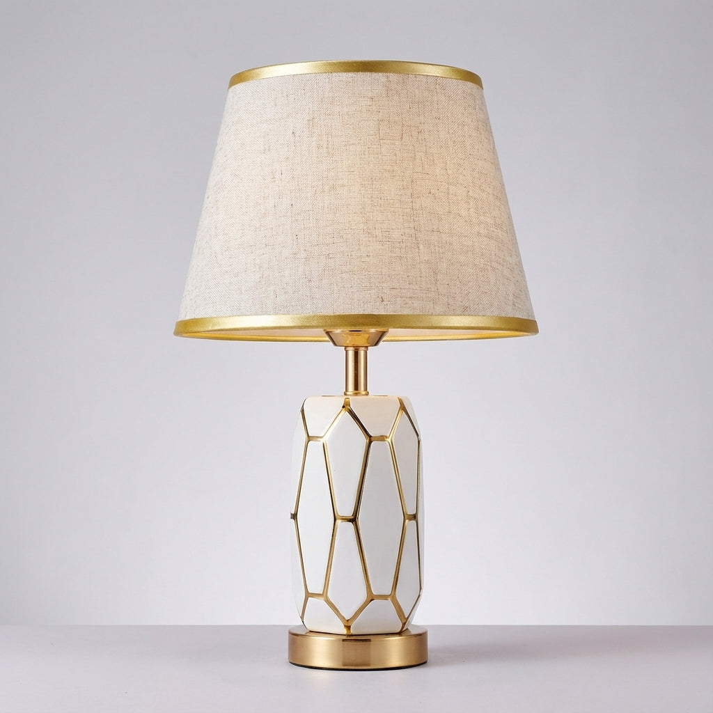 Versatile ceramic desk or table lamp with a cylindrical fabric shade, offering warm ambient light.