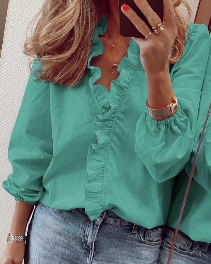 Stylish orange women's long sleeve blouse featuring elegant ruffles & a flattering V-neckline.