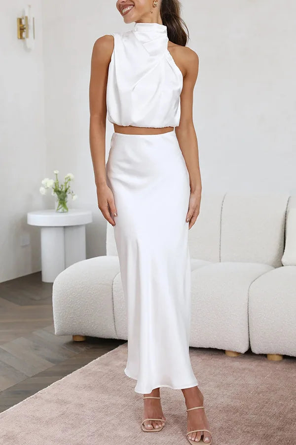 Minimalist chic women's two-piece evening set: elegant draped halter top with a stylish flowing maxi skirt.