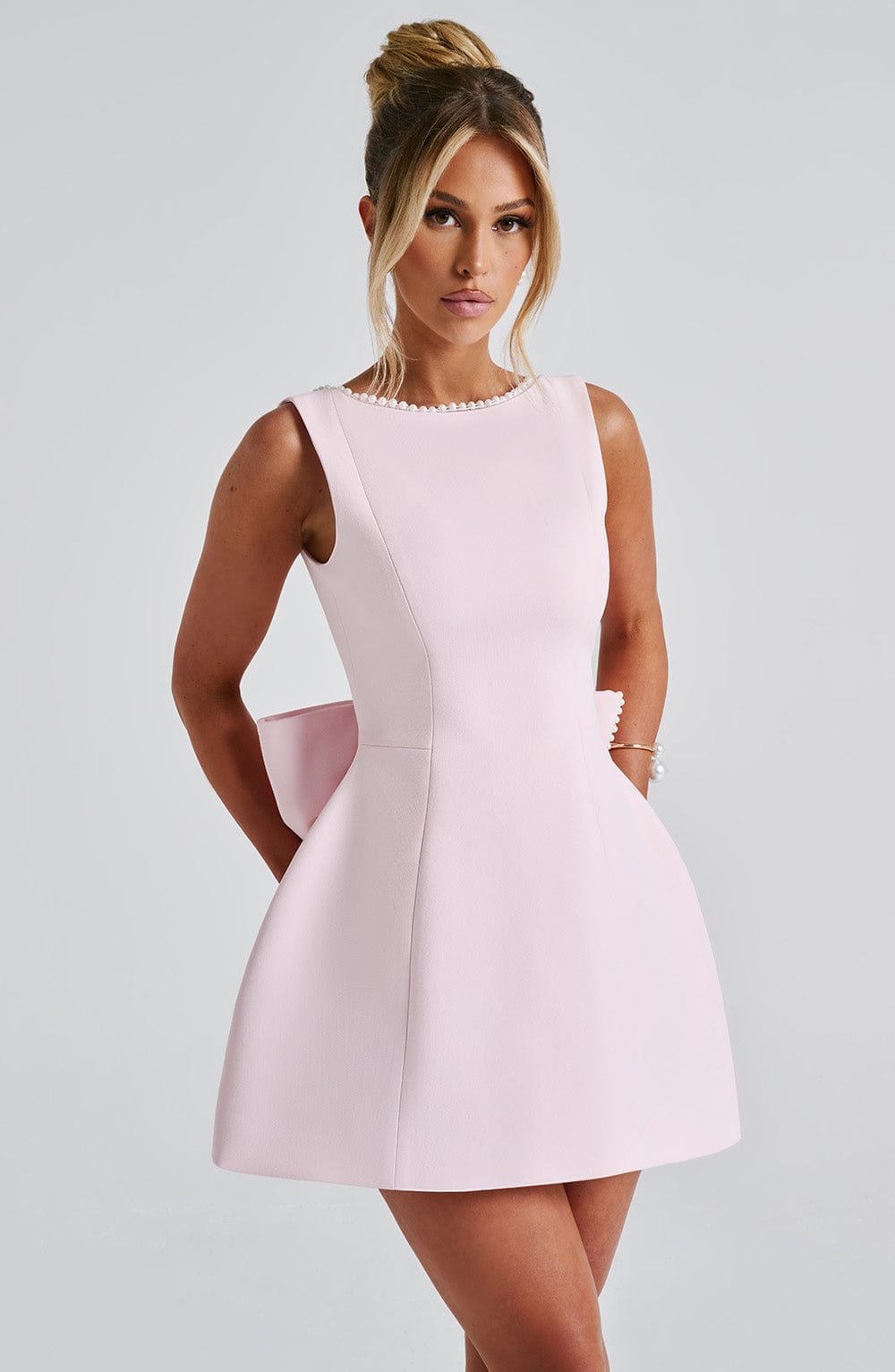 Stylish women's short party dress featuring A-line silhouette and beautiful pearl embellishments.