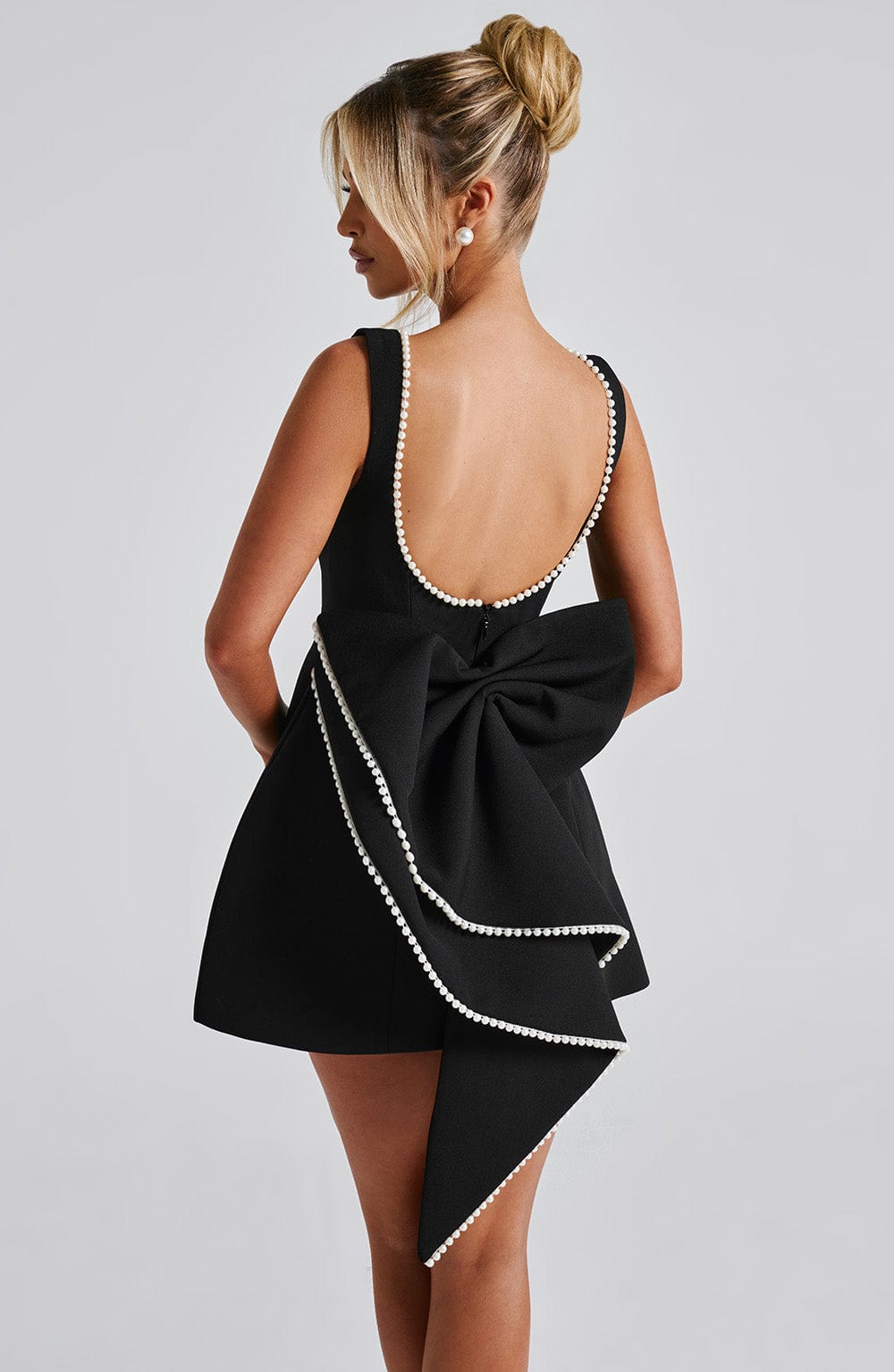 Chic women's homecoming mini dress, A-line cut with luxurious pearl trim. Perfect party attire.