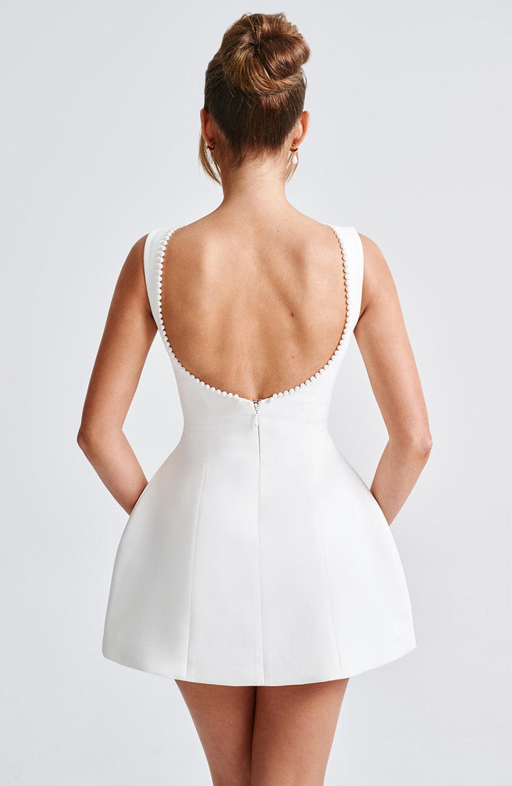 Party-ready women's mini dress, A-line fit, featuring elegant pearl detailing for a classy look.