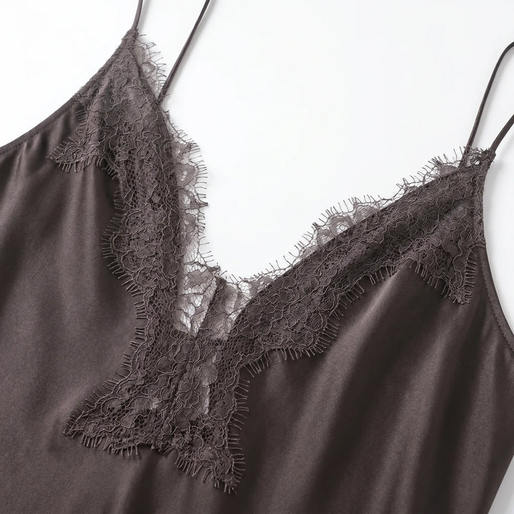 Women's stylish backless asymmetrical slip dress, a flowy midi with v-neck and elegant lace detail, suitable for occasions.