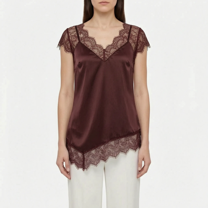 Chic women's top with asymmetrical hem & elegant sheer details. Sleeveless design offers sophisticated summer fashion.