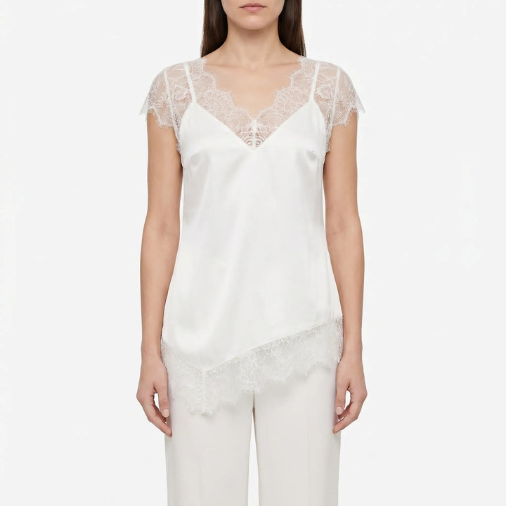 Lightweight women's asymmetrical blouse, sleeveless with sheer accents & a V-back, offering elegant casual chic.