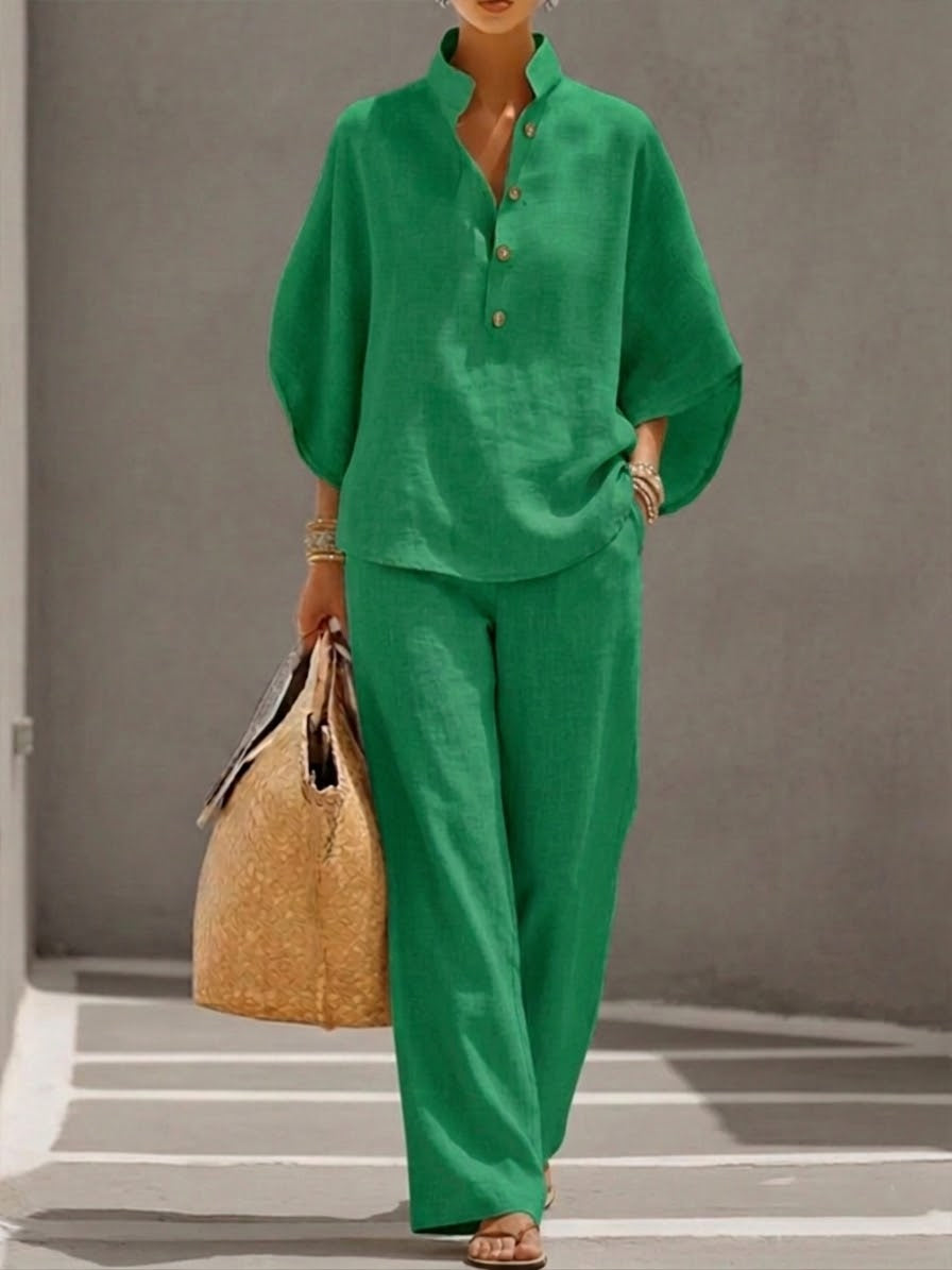 Stylish women's elegant batwing blouse and wide trousers set, perfect for a chic and modern casual outfit.