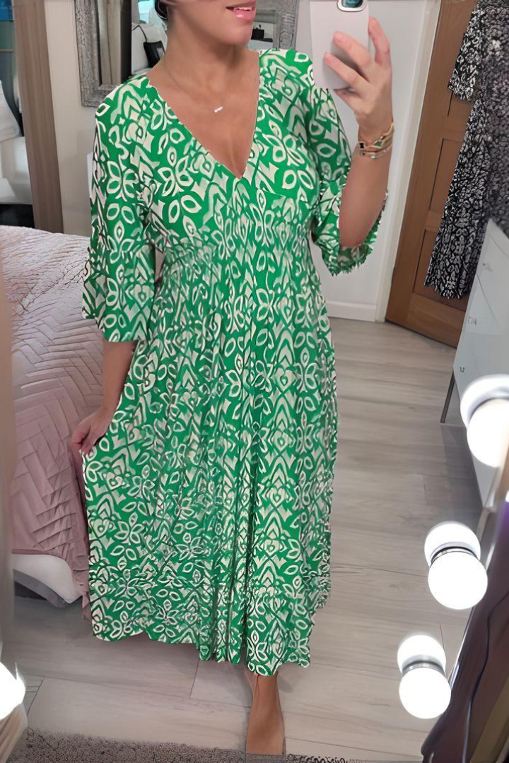 Chic women's elegant midi dress featuring a beautiful print & flattering belt. Great for spring/summer events.